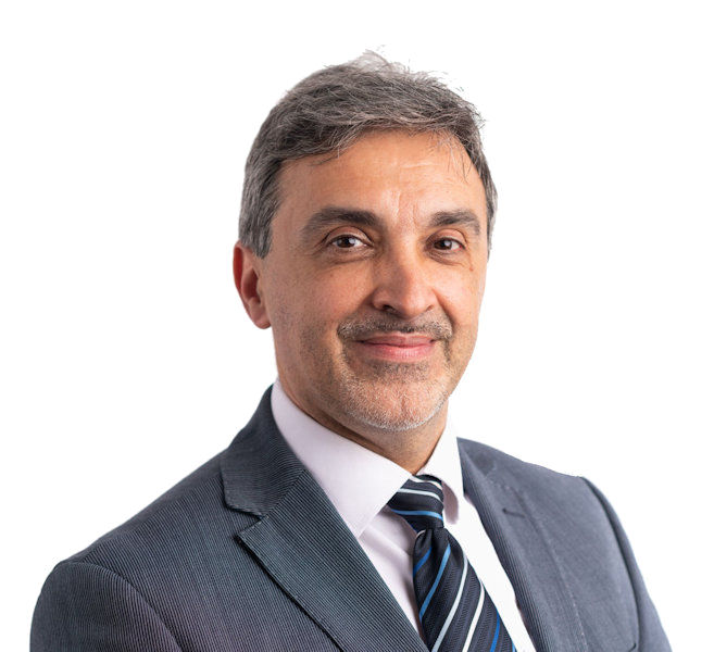 Photo of Mr. Dan Arvinte (Orthopaedic Surgeon) in a suit smiling.